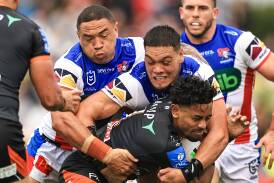 THe Knights wrap up Tigers fullback Jahream Bula. Picture Getty Images
