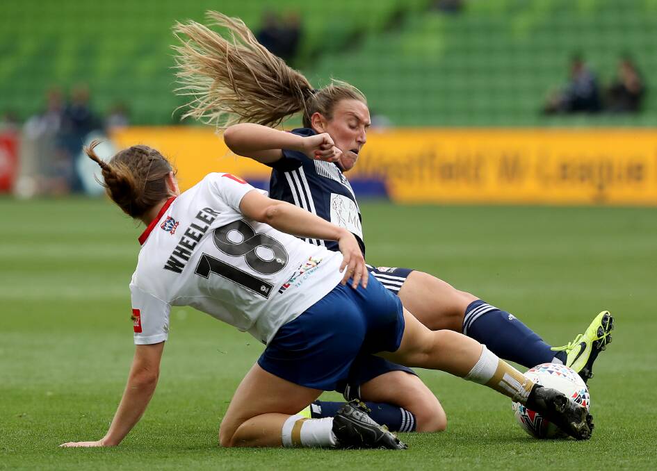 TUSSLE: Newcastle's Clare Wheeler and Annalie Longo of Melbourne Victory battle for the ball at AAMI Park. Picture: Jonathan DiMaggio/Getty Images