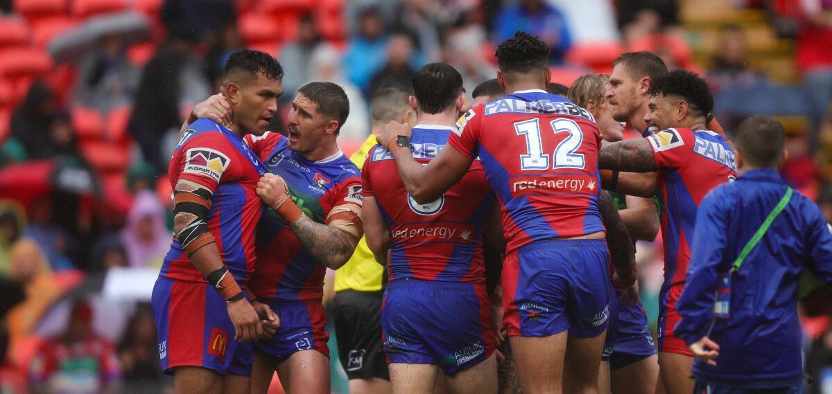 The Knights celebrate Daniel Saifiti's try against the Warriors on Sunday. Picture by Marina Neil