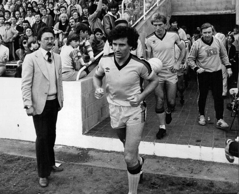 LOCAL HERO: Craig Johnston leads KB United out onto the pitch to take on St George at Barton Park in June 1982. Picture: Gerrit Alan Fokkema. 