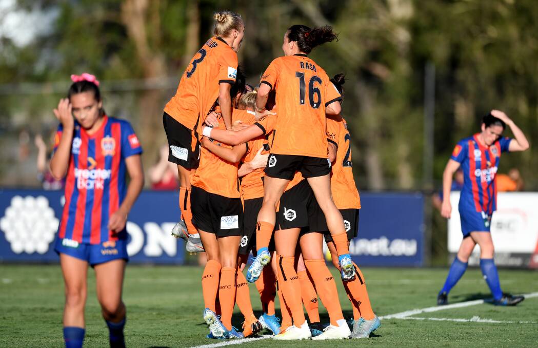 DOWN: Brisbane Roar celebrate the winning goal from Hollie Palmer on Sunday. Picture: Getty Images