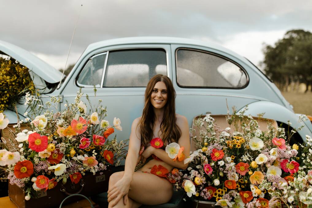 In full bloom: The Naked Florist founder Ashleigh Palmowski and her blooms for the Naked for Change calendar, on sale November 2. Picture: House of Lucie