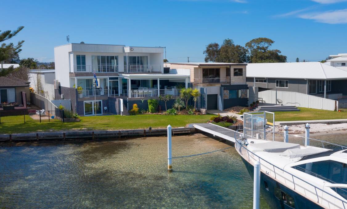 The custom-built home at 1/100 Marks Point Road fronts Swan Bay with a private jetty that currently houses a 70-foot cruiser. 