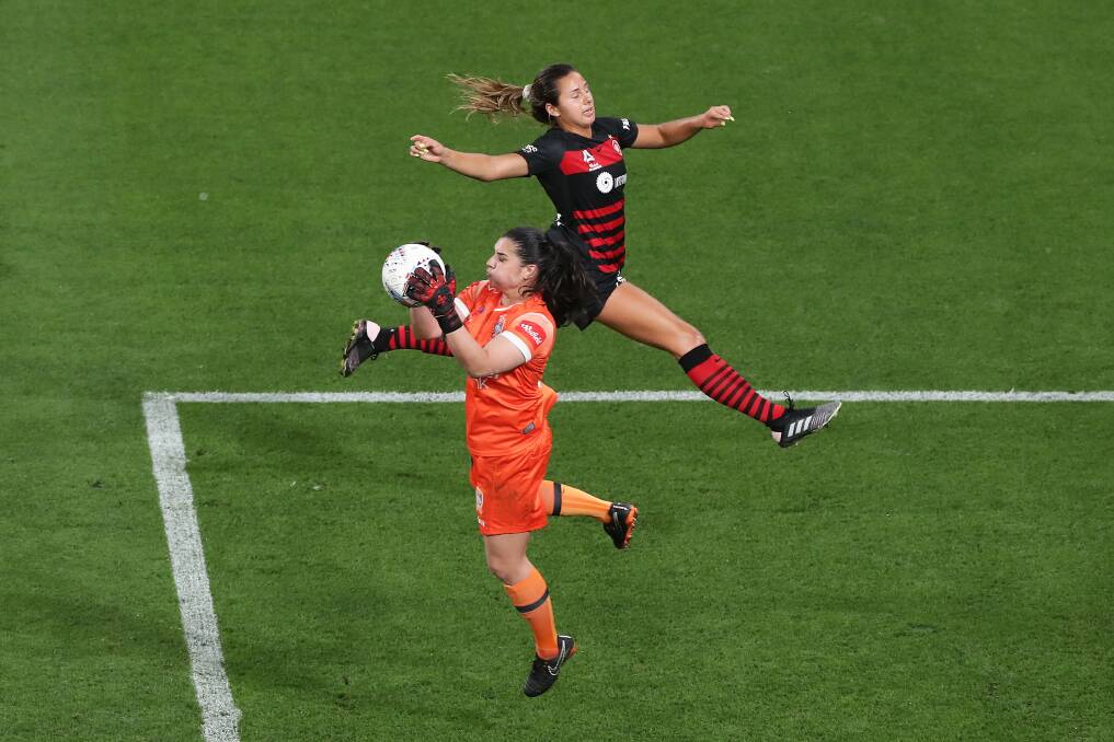 Jets goalkeeper Claire Coelho takes the ball as Sam Staab of the Wanderers attacks during the round-two W-League match at Bankwest Stadium on Friday night. Picture: Matt King/Getty Images
