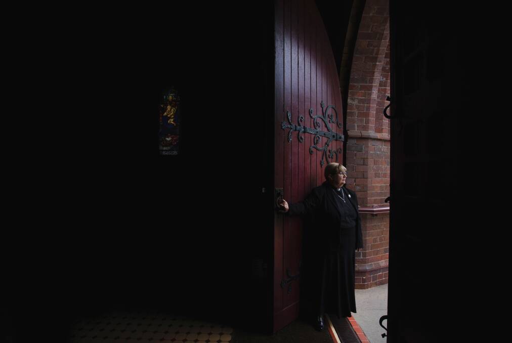 The Anglican Dean of Newcastle, the Very Reverend Katherine Bowyer, shutting the doors of Christ Church Cathedral. Picture: Marina Neil