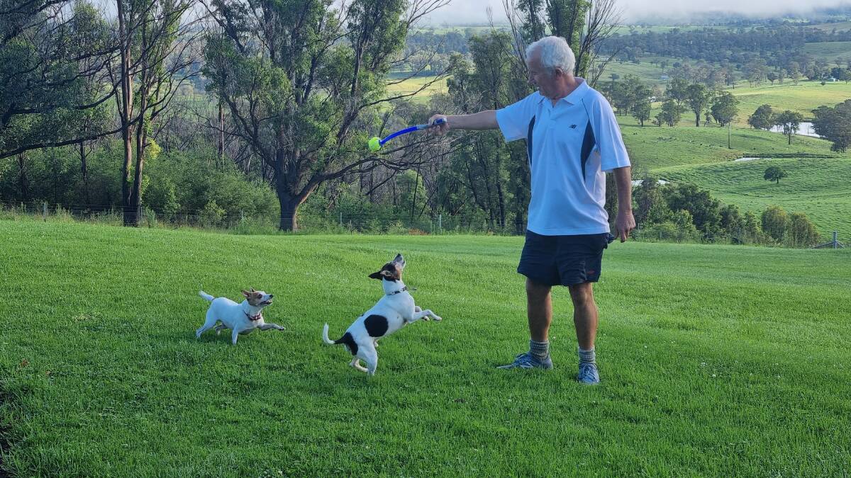 Nigel Wiggins has always been a very active and fit person. Here he is playing with his two dogs Zoe and Bossy. Photo: supplied 