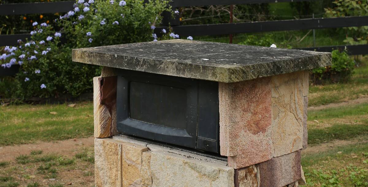 Layers upon layers of coal dust can be seen settled atop the Leslie's sandstone mail box. Picture: Simone De Peak