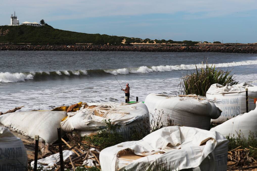 CARNAGE: The sun comes out at Stockton Beach on Sunday after being hammered by yet another king tide and massive swells, leaving behind masses of debris. Pictures: Peter Lorimer 
