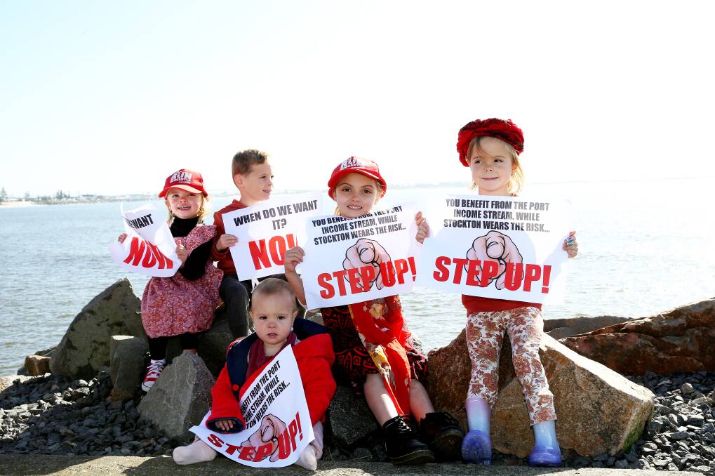 Concerned youngsters Florence Grainger, 2, Jett Senior, 5, Eily Senior, 1, Macy Grainger, 5, and Eden Senior, 5, joined in the protest to save Stockton Beach. Hundreds of Hunter protesters lined Stockton breakwater to raise awareness of worsening erosion problems on July 17, 2022. Picture by Peter Lorimer.