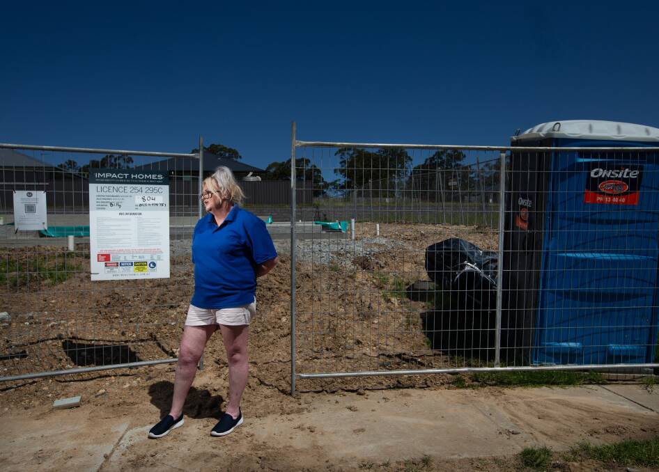 ABANDONED SITE: Sara Conlan at the concrete slab in Raymond Terrace, where her dream home was supposed to be ready to move into in February. Picture: Marina Neil