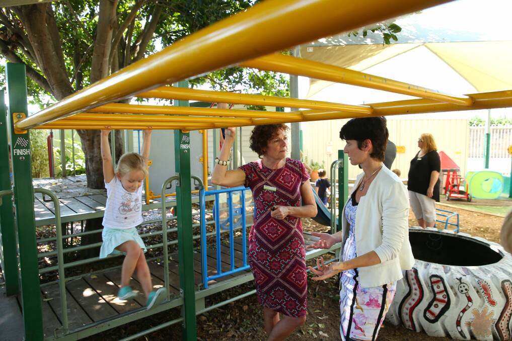 Kate Washington, Minister for Family and Community Services, pictured talking to a Maitland preschool teacher, says she is determined to fix the broken child protection system, 'but it won't happen overnight'. Picture by Max Mason-Hubers