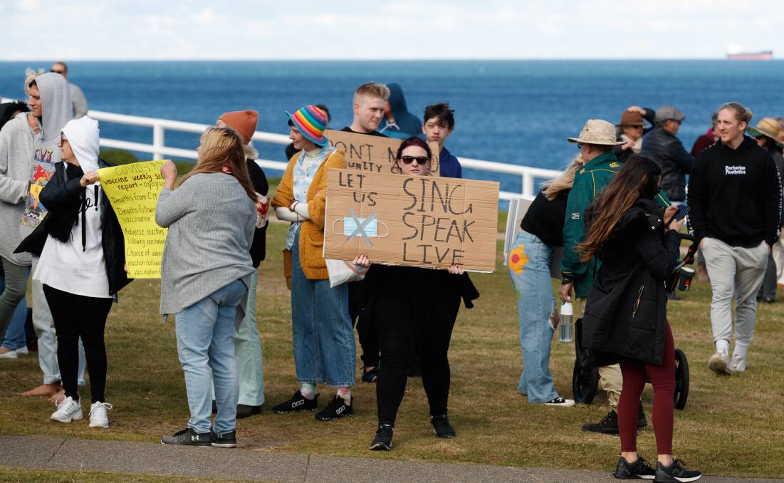 Bar Beach: People holding placards condemning COVID-19 restrictions at Bar Beach on Saturday.