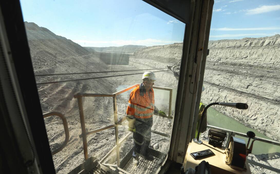 A dragline operator works the coal face at Hunter Valley Operations. Picture by Marina Neil.