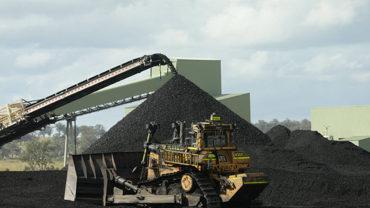 MACH Energy, which runs Mount Pleasant coal mine at Muswellbrook, declined to comment on allegations that a modifications loophole is being used to escape detailed scrutiny. Picture - of coal being transported from Mt Pleasant into a silo and emptied into trucks underneath - by Jonathan Carroll.