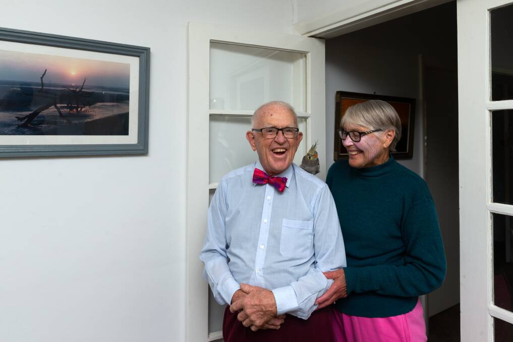 Dr Lachlan Lang, a retired gynaecologist and obstetrician renowned for wearing a bow tie to work as well as for his professionalism and dedication, pictured at home with his wife, Bronwen, and "Cammy". Picture by Jonathan Carroll