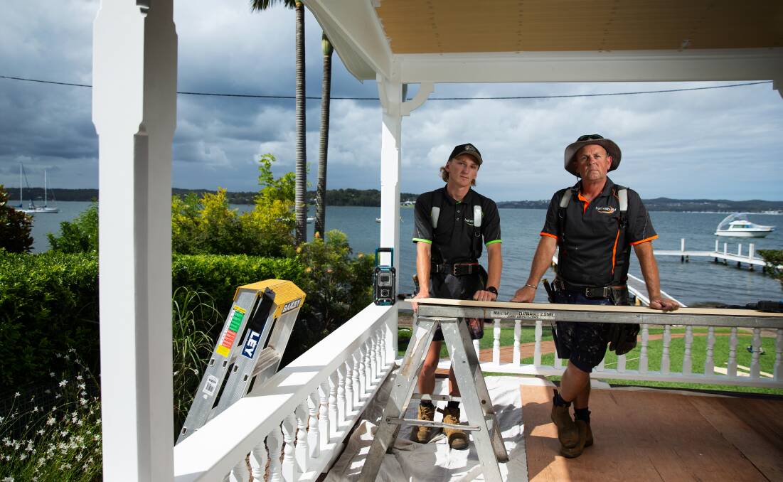 Matthew Haines, pictured with second-year apprentice Jayden Milne, working at a home in Toronto overlooking Lake Macquarie. Picture: Marina Neil