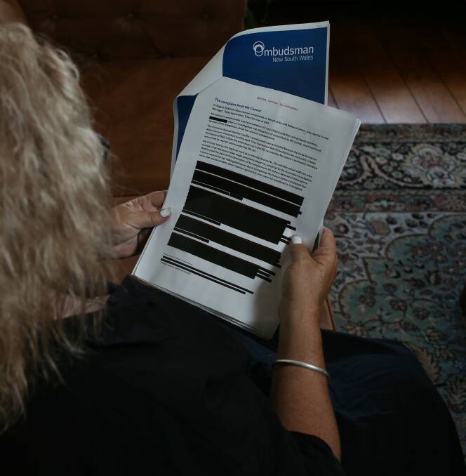 Rebecca Connor reads her heavily redacted copy of the 'secret' NSW Ombudsman's report into the handling of her claims of corruption and misconduct. Picture by Simone De Peak.