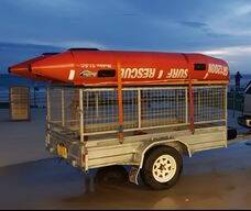 Missing: The stolen nippers trailer, pictured here with a rescue boat on top, is a full cage with a mesh roof and sides and a lockable rear gate. It had galvanised wheels - not the white wheels shown here.
