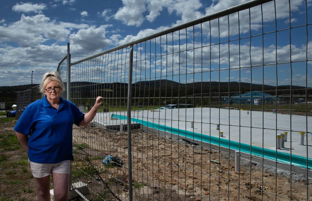 ABANDONED SITE: Sara Conlan at the concrete slab in Raymond Terrace, where her dream home was supposed to be ready to move into in February. Picture: Marina Neil 