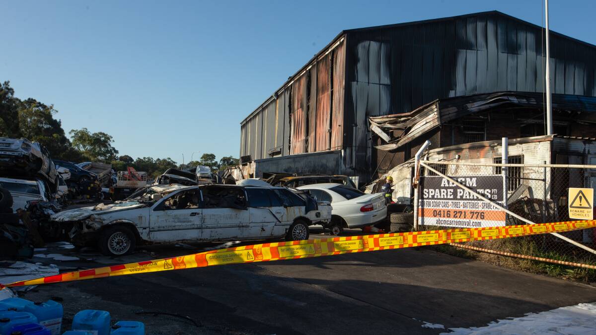 Fire and Rescue NSW (FRNSW) investigators are trying to determine the cause of a large blaze this morning in a Newcastle car wrecking yard. Pictures: Marina Neil