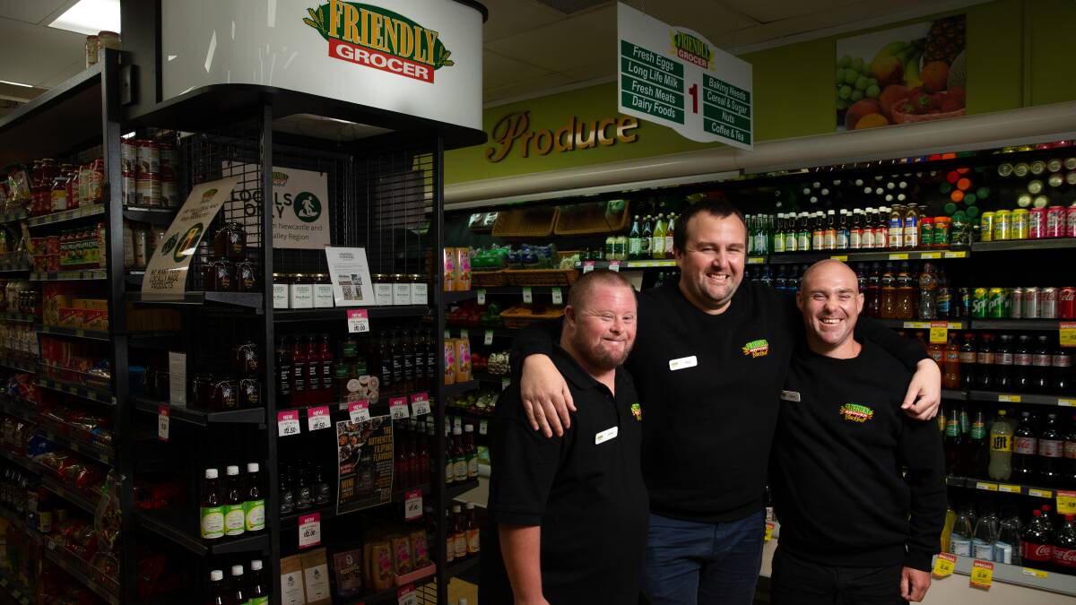 More than groceries: Friendly Grocer store manager Joey Tierney, centre, with work experience participants Daniel Burgess and Simon Schofield. Picture: Marina Neil.