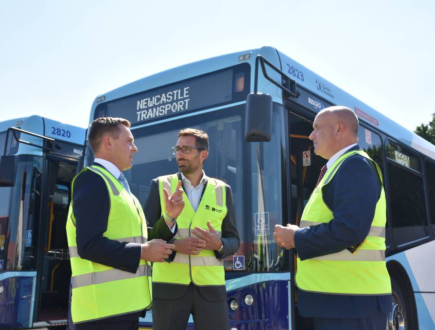 Electric future: Taylor Martin, Emmanuel Genlot and Minister David Elliott at Hamilton Bus Depot for the "net zero" buses announcement on Tuesday. Picture: Ethan Hamilton