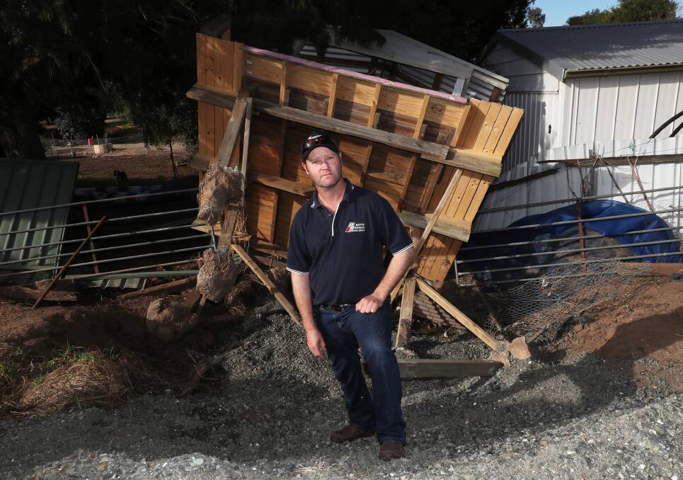 Colin Latham and his son's cubbyhouse, uprooted by July floods. Picture: Peter Lorimer