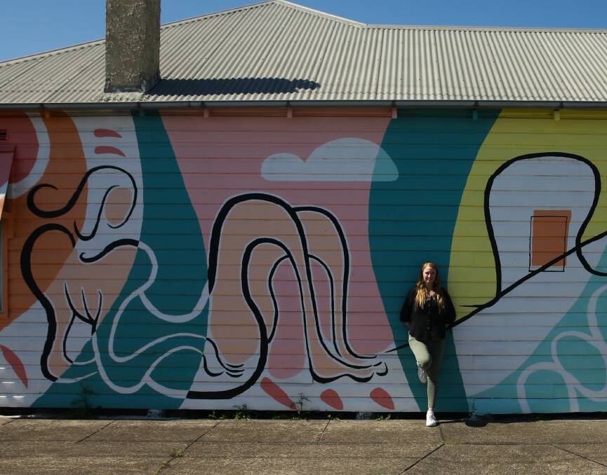 Colour: Jacinta Fintan at a mural by husband, Nick. Picture: Jonathan Carroll 
