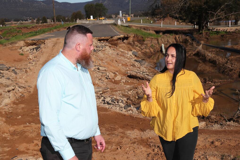 Hunter MP Dan Repacholi and Angela Andonopoulos at Broke Road destroyed by July floods. Picture by Peter Lorimer