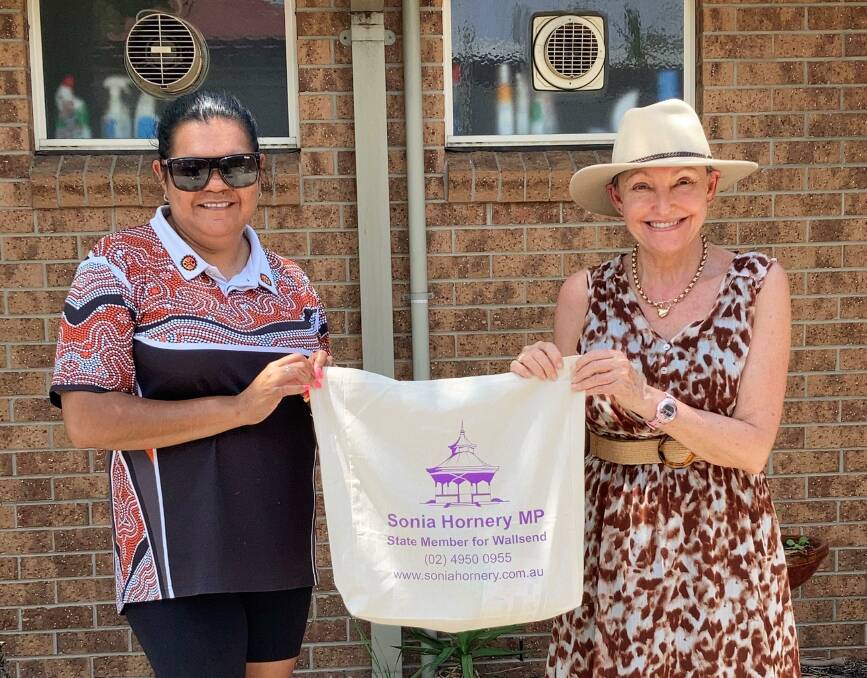 MP Sonia Hornery donating her tests to Paula from Warlga Ngurra Women and Children's Refuge.