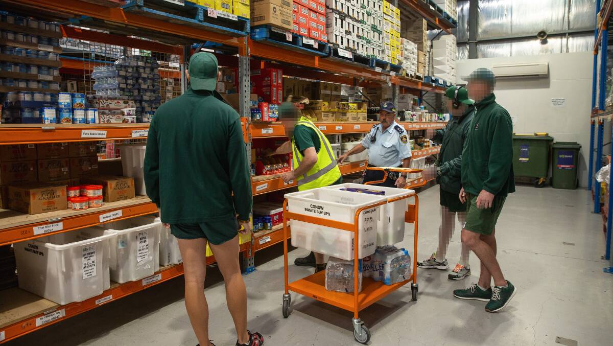 Inmates working in the grocery buy-ups warehouse which stocks items like toiletries, soft drinks and food. Picture by Marina Neil.