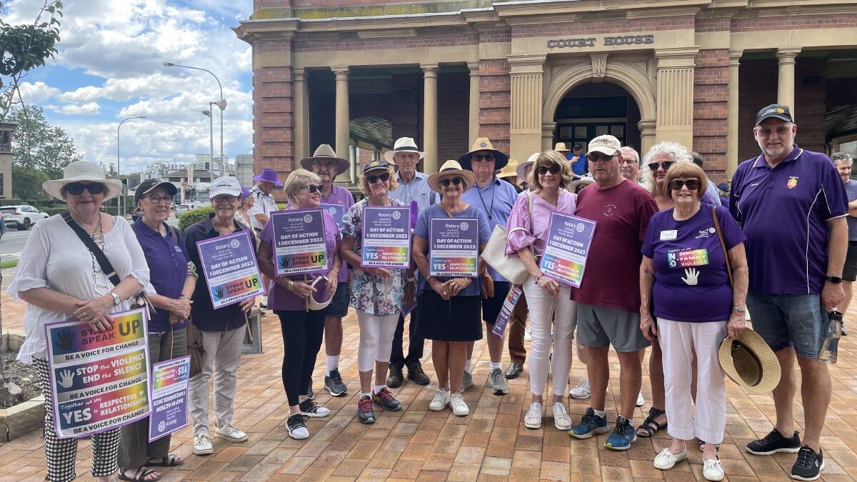 Rotarians gathered outside Maitland Court House for the march against domestic violence, including Christine Walmsley (second from right). Picture by Chloe Coleman
