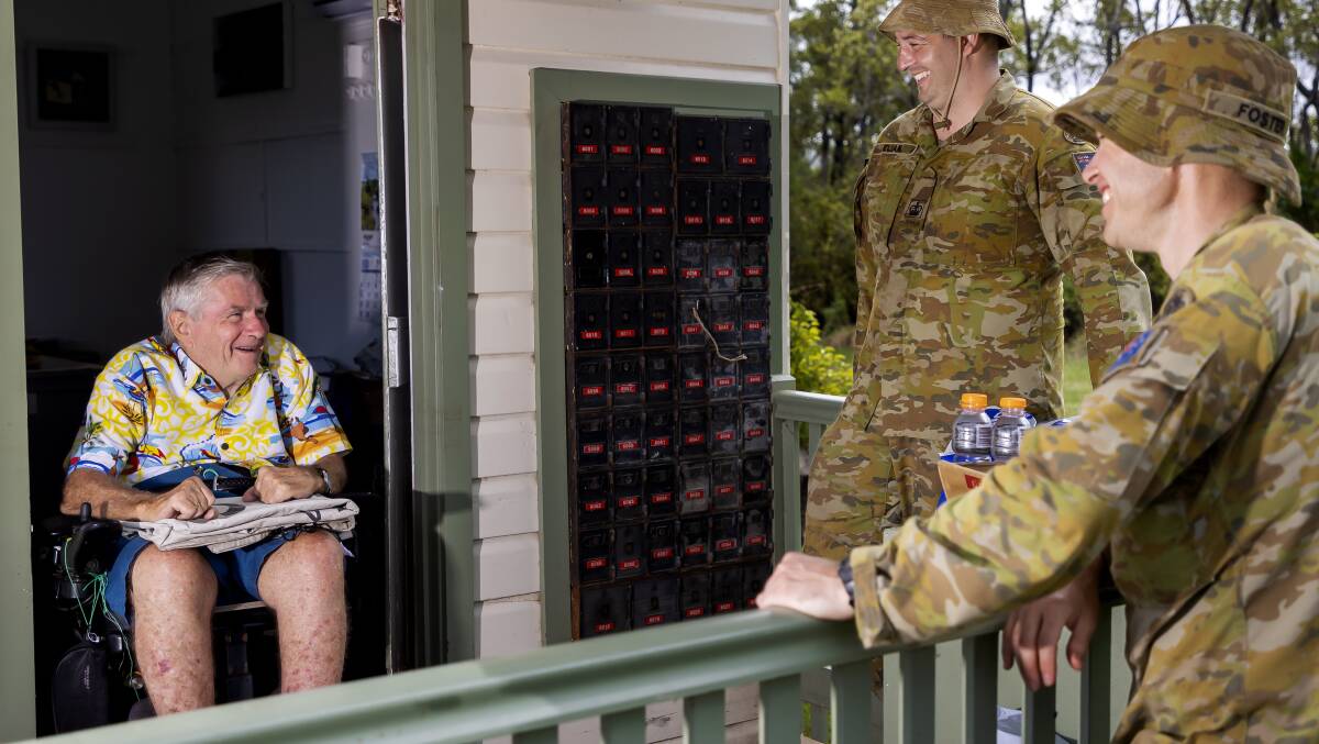 Australian Army soldiers Warrant Officer Class Two Robert Elian (left) and Warrant Officer Class Two Michael Foster with Mr Gary Carr, Empire Vale Post Office manager, after providing flood damage clean-up assistance as part of Operation Flood Assist 2022.