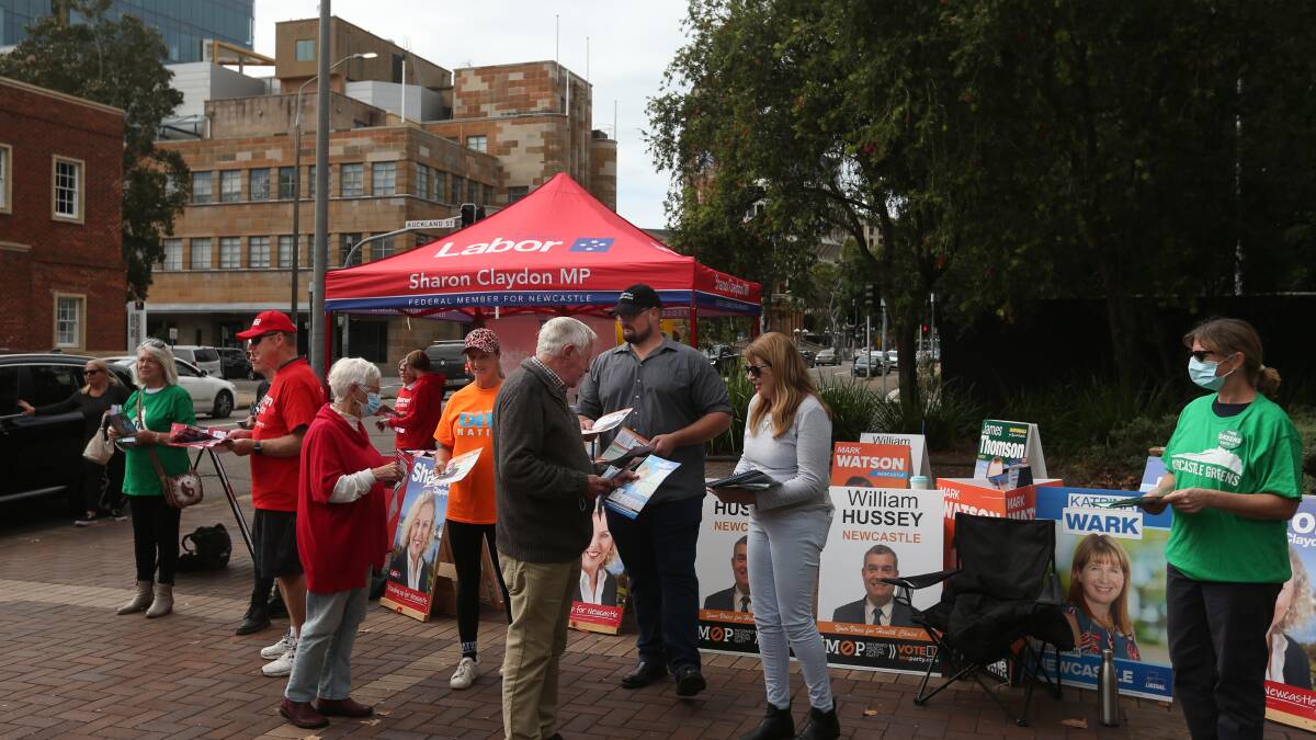 It is on: Candidates and party volunteers handed out how-to-vote cards to a steady number of early voters at King Street. Picture: Simone De Peak 