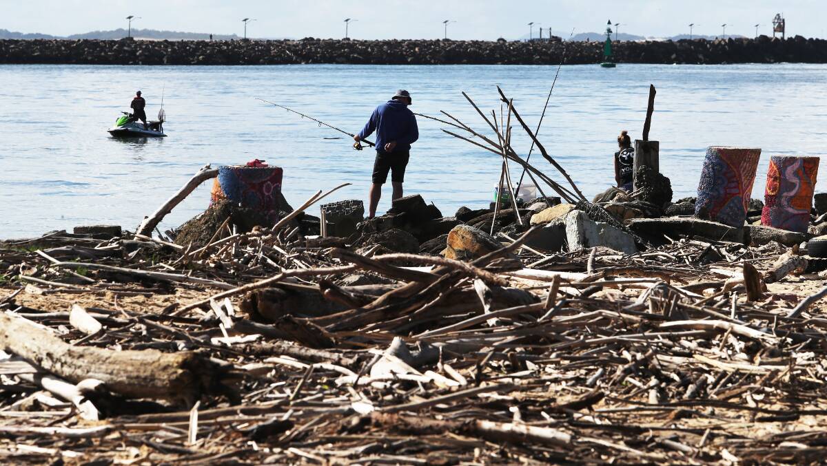 Covered: Newcastle's Horseshoe Beach is covered in debris following high tides. Picture: Peter Lorimer