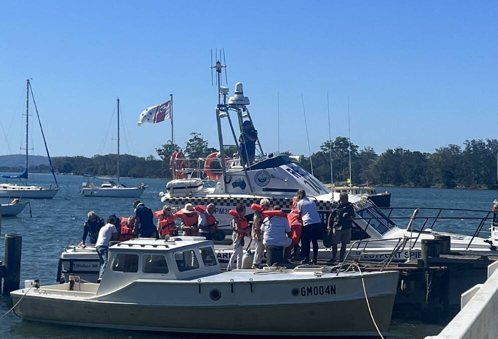 Marine Rescue Port Macquarie assisted the men and women off the Hibbard Ferry ramp off Hastings River Drive. Picture by Mardi Borg