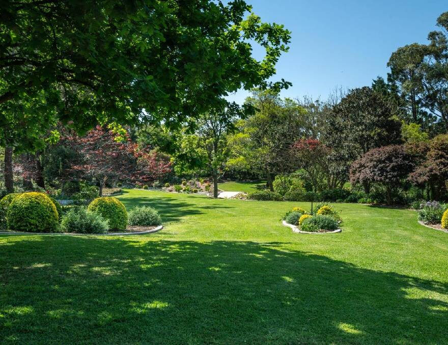 The acreage has manicured gardens, lawns and established trees around the grounds. Picture supplied