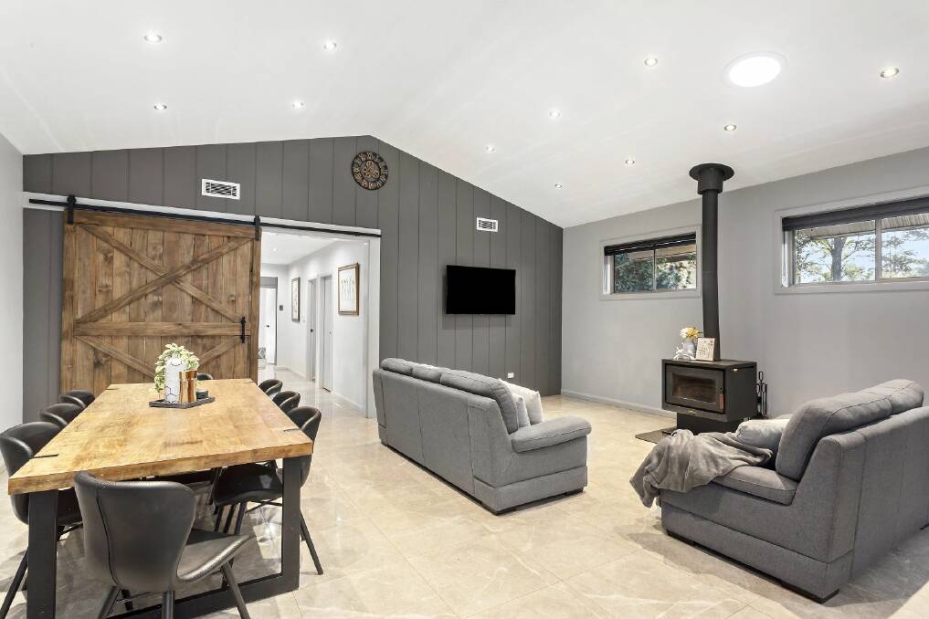 The shed house includes a combustion fireplace and a rustic barn door in the living area. Picture supplied