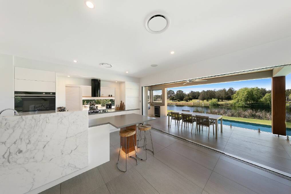 The open-plan kitchen and dining area flows out to the covered alfresco balcony. Picture supplied