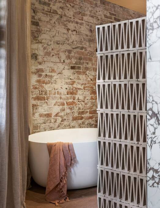 Geometric-patterned European terracotta breeze blocks are used as a shower screen. Picture supplied