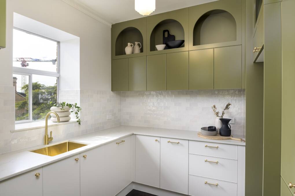 The two-tone kitchen is designed to reflect the building's art deco style.