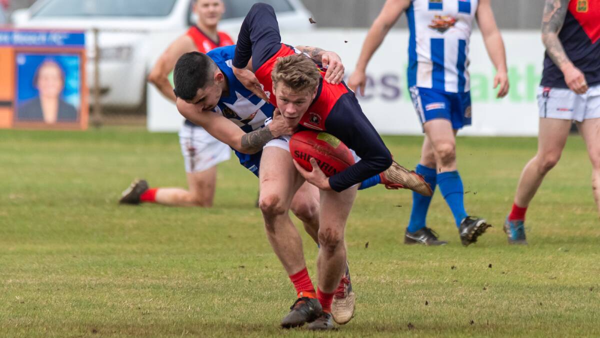 Motton Preston's Johnty Devries tries to break clear of a tackle from Turners Beach player Joshua Barker. Picture by Simon Sturzaker
