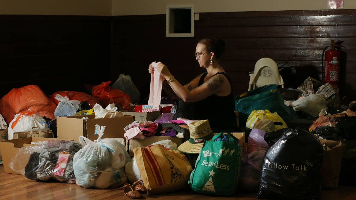Abermain Hotel owner Cass Ponchard sorting through "dozens" of bags of generous donations. Picture by Simone De Peak