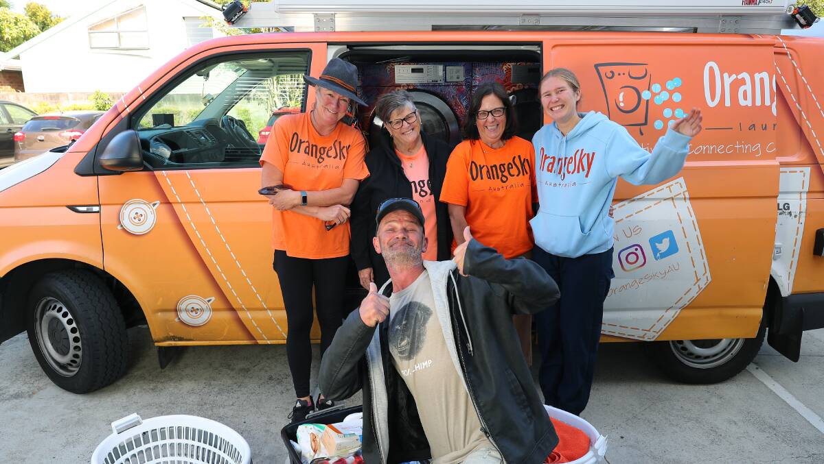 Orange Sky volunteers Gayle Farthing, Jillian Greer, Kim Howe and Hannah Arundell with laundry service user Geoff Smith. Picture by Peter Lorimer