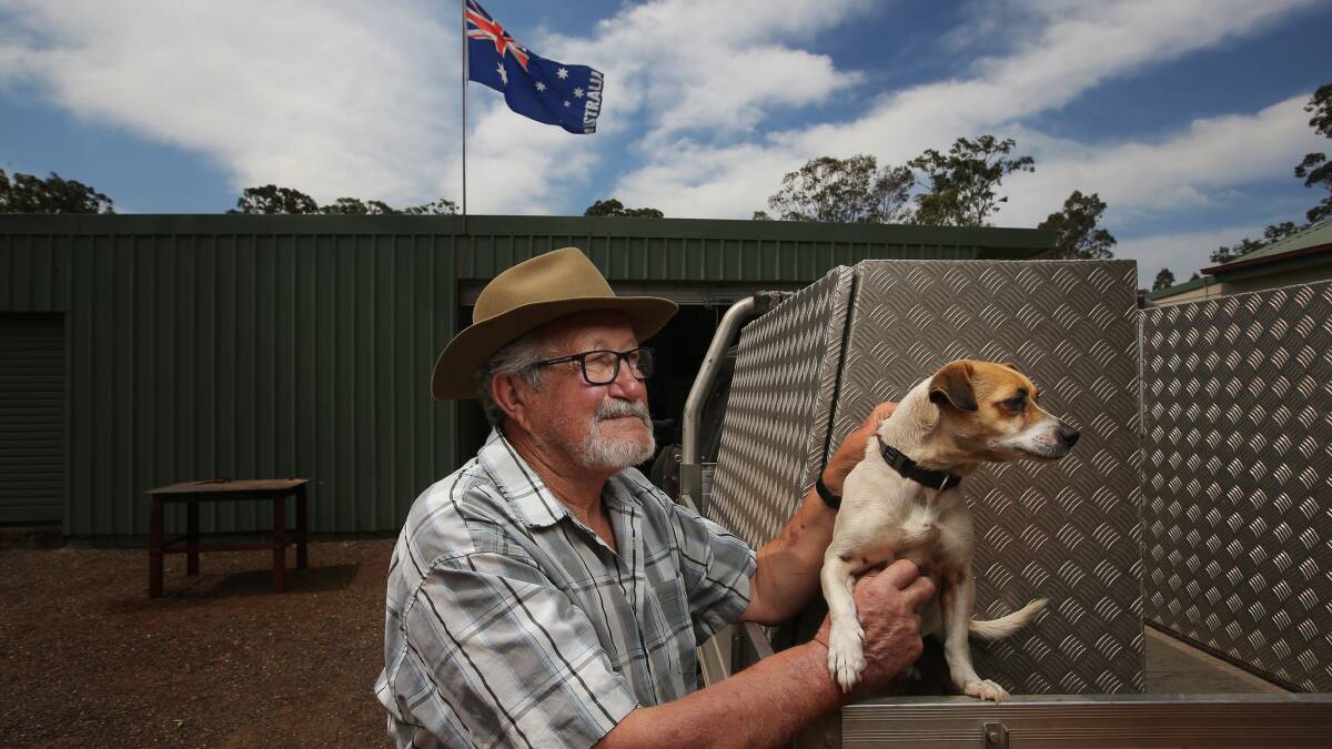 Bill Ingall with his dog Mason at their home in Kearsley. Bill uses the flag atop his shed to monitor the direction of fires. Picture by Simone De Peak