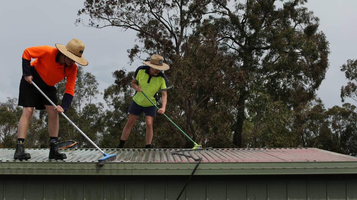 LLoyd and Scott spent hours scrubbing their shed roof. Picture by Simone De Peak