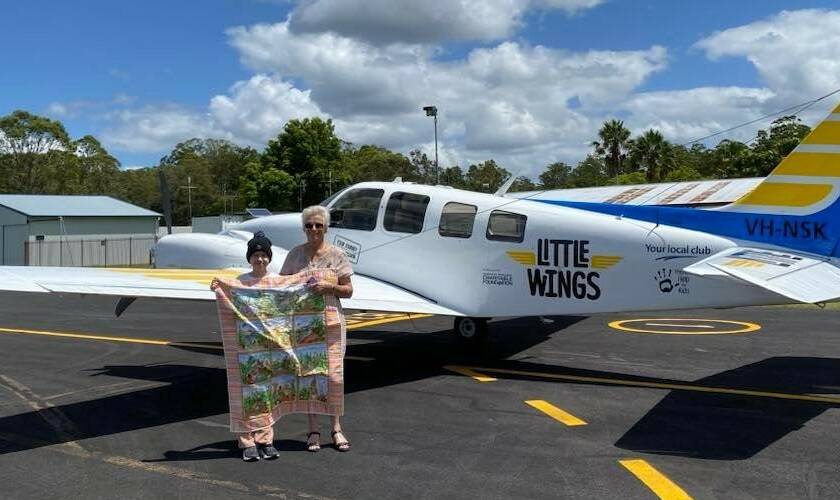 Isabelle Northey holds one of Glenda's quilts before leavig on a Little Wings flight. Picture supplied