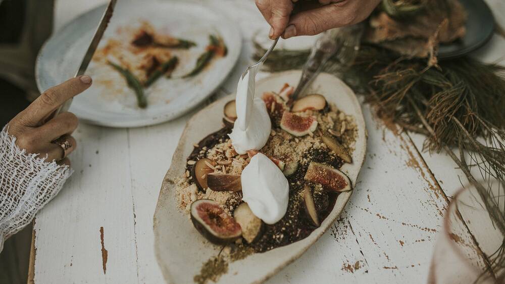 Dessert: Caramelised fig, wild berry crumble, cinnamon crumb , vanilla bean cream prepared by Cooper Thomas on a wilderness experience at Stockton Beach. Picture: Joel Alston, Barefoot & Bearded