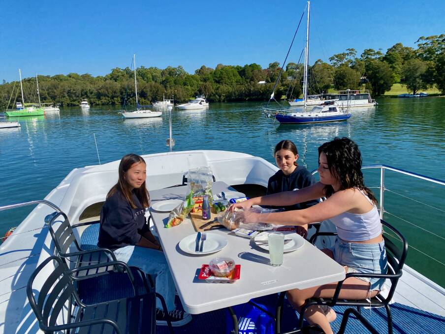 Lunch atop a houseboat on Lake Macquarie. Picture by Daniel Scott