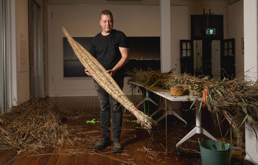 Indigenous artist Mitch Mahoney on day one of building a reed canoe onsite at Maitland Regional Art Gallery as part of the Upriver, Downriver exhibit. Picture by Marina Neil